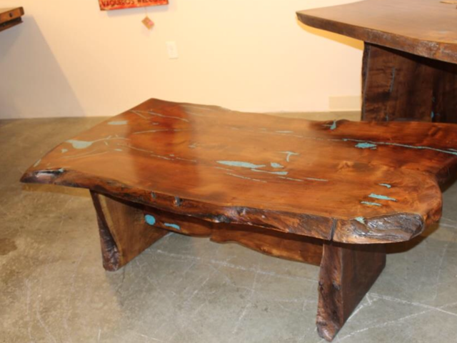 A wooden table is sitting on a concrete floor in a room
