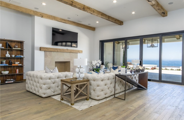 A living room with a fireplace and a flat screen television