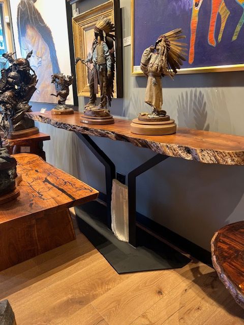A wooden shelf with statues on it in a room