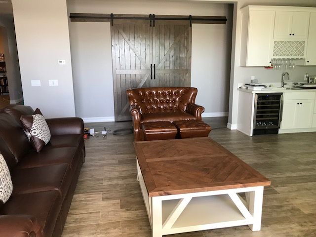 A living room with a couch a chair and a coffee table