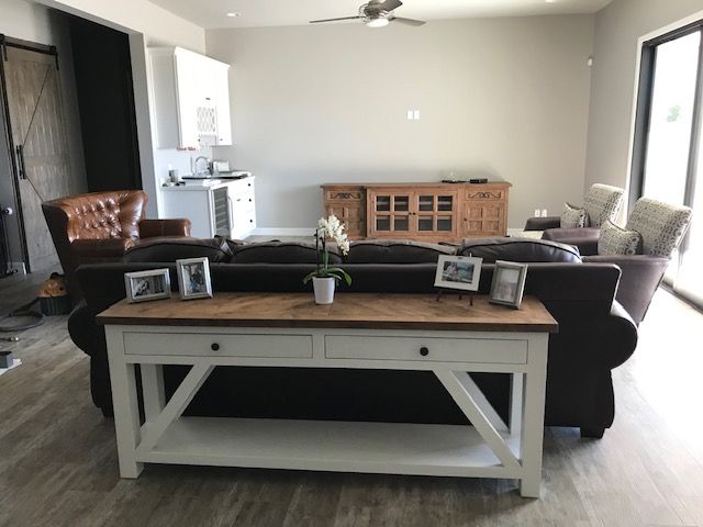 A living room with a couch and a table with pictures on it