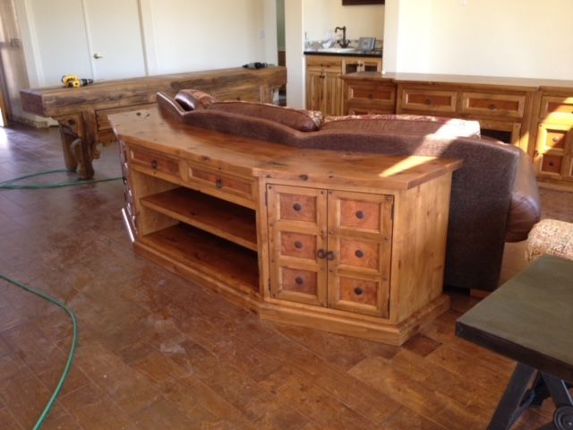 A living room with a couch and a wooden cabinet