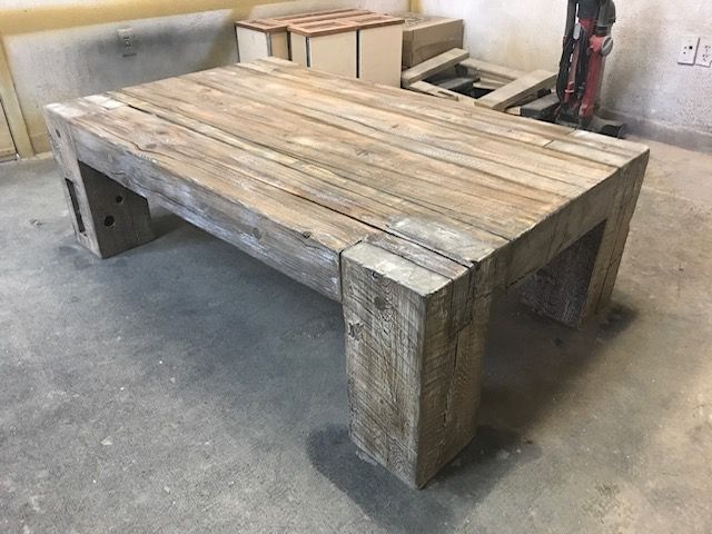 A wooden table is sitting on the floor in a room