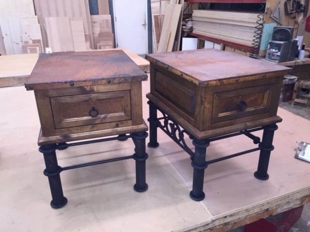 Two wooden tables with drawers on top of a table