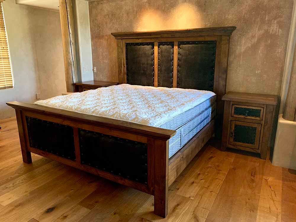 a bedroom with a bed , nightstand , and mattress