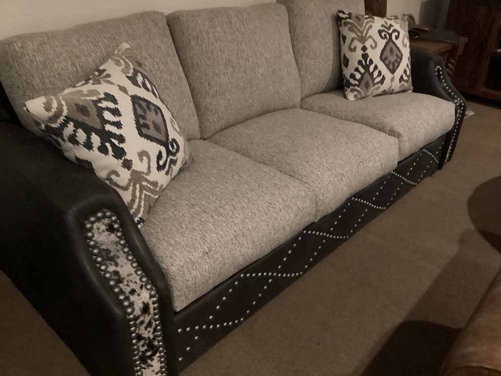 a couch with two pillows on it is in a living room