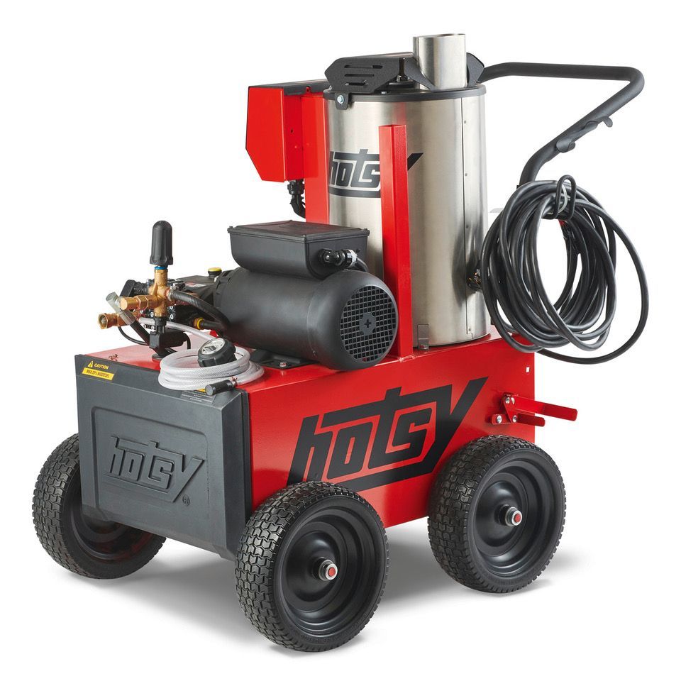Red industrial hot water pressure washer on four wheels with hose and tank