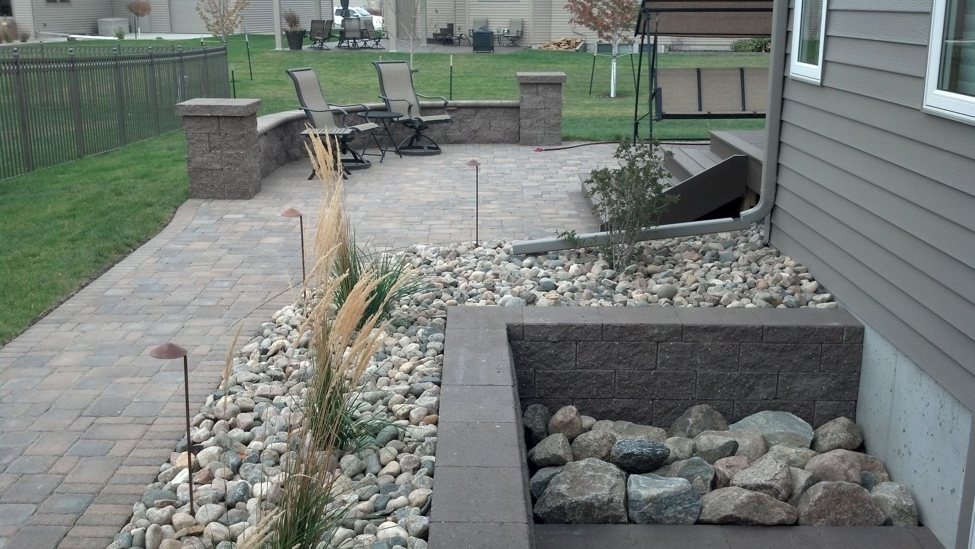 A house with a patio and rocks in front of it