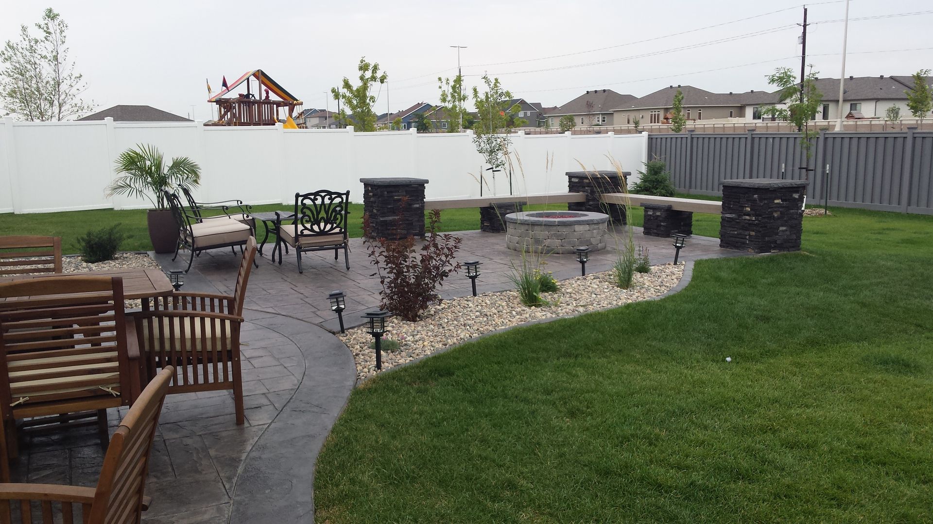 There is a fire pit in the middle of the backyard.