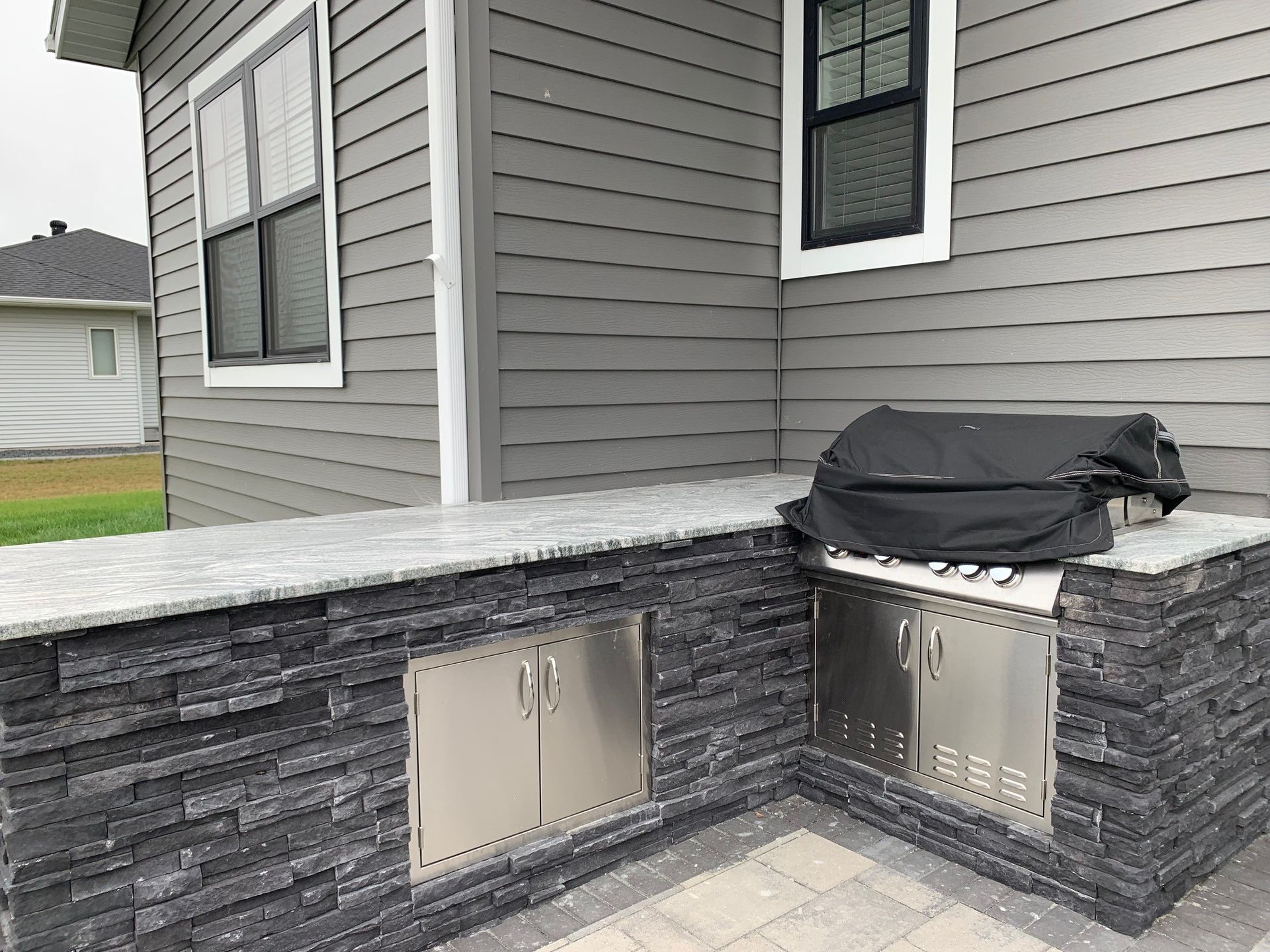 A grill is built into the side of a house.
