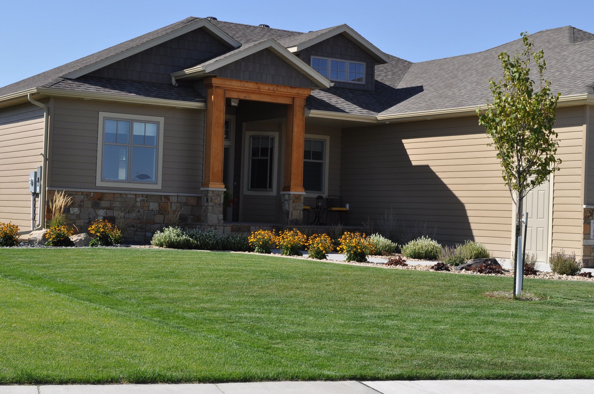 A house with a lush green lawn in front of it