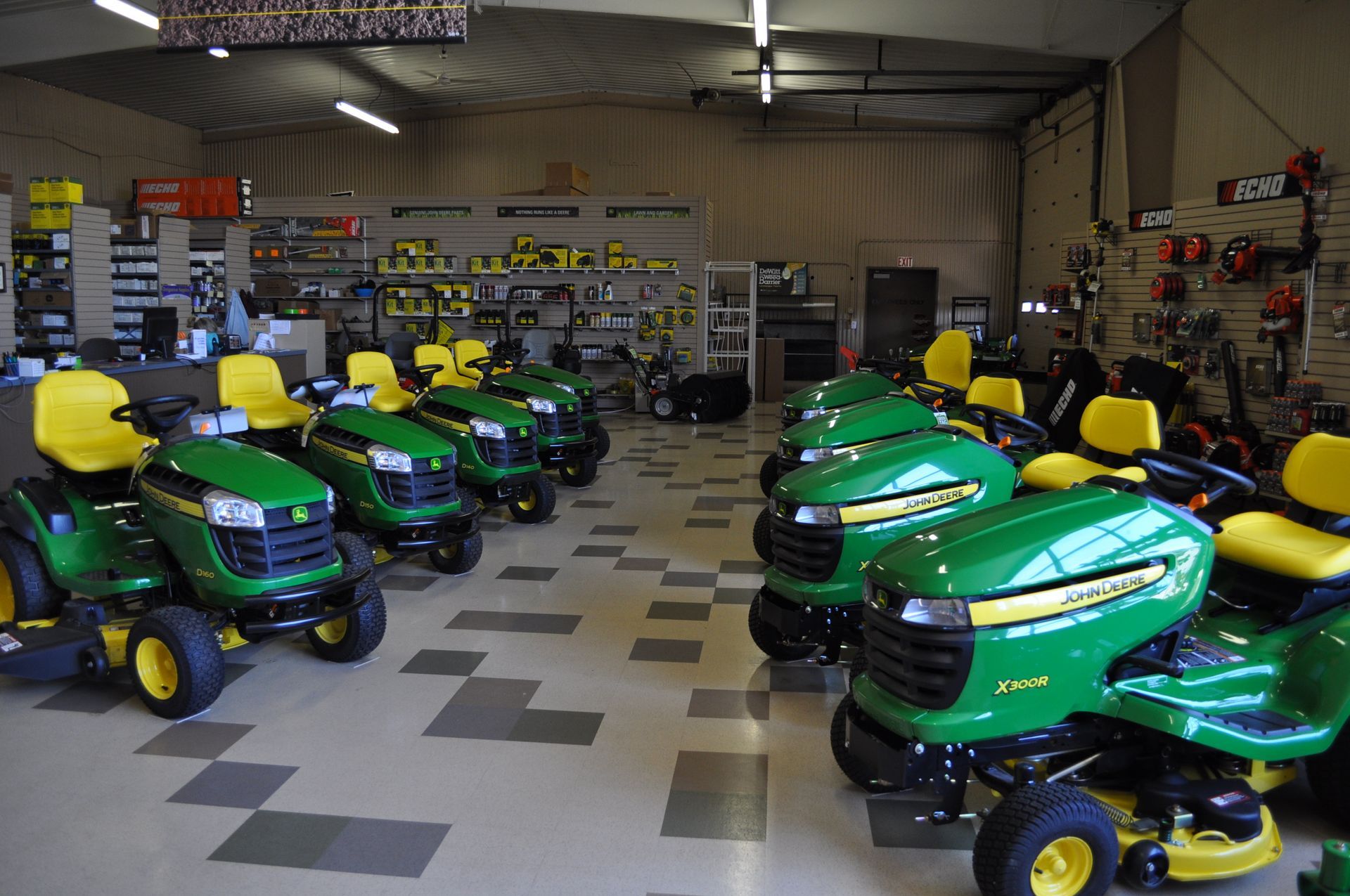 A row of john deere lawn mowers are lined up in a store