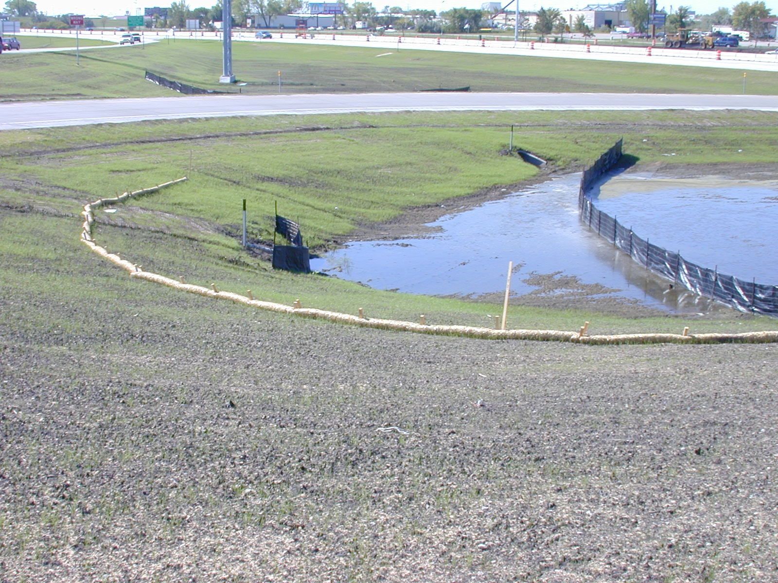 A puddle of water in the middle of a field