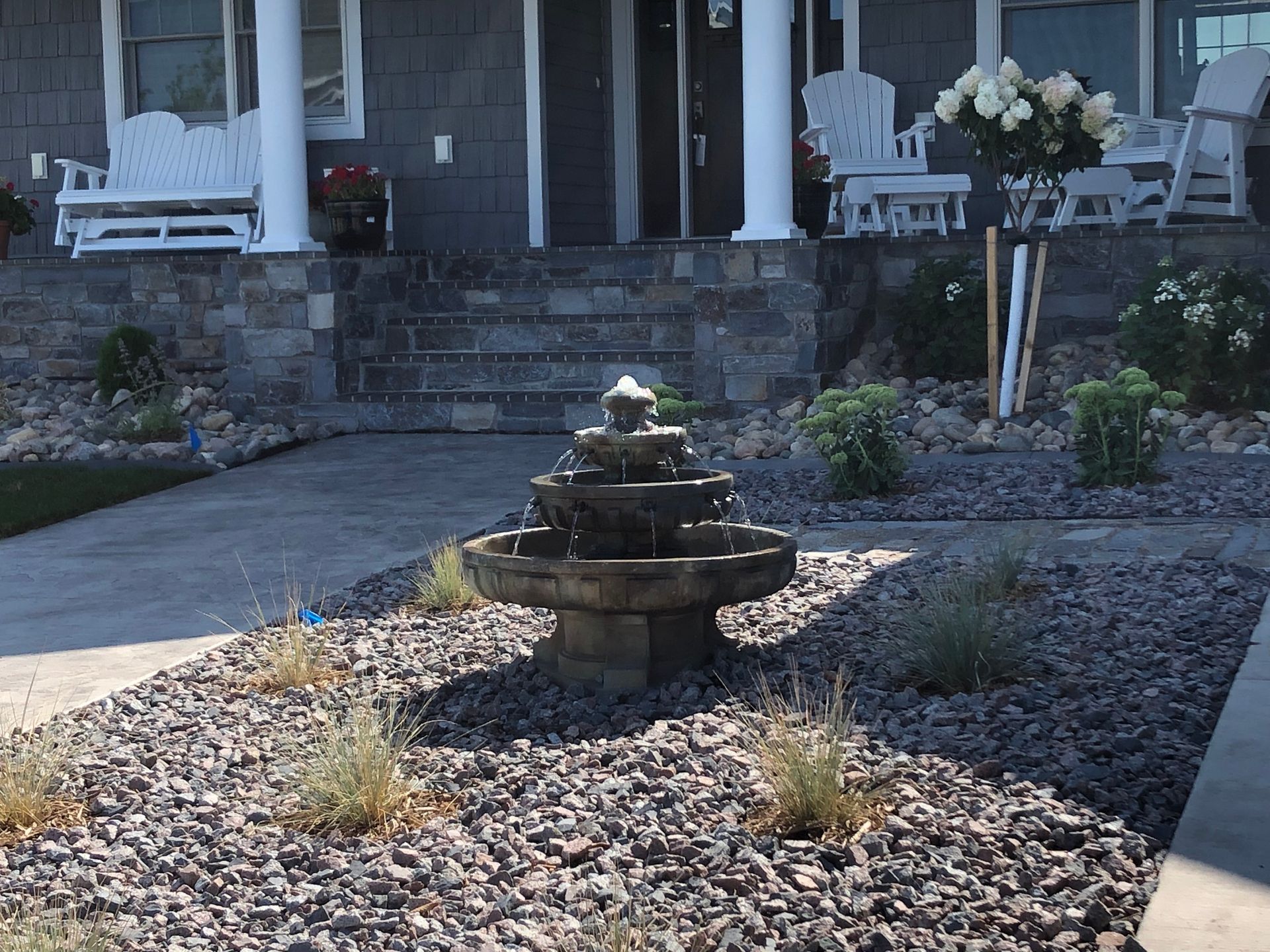 A house with a fountain in front of it