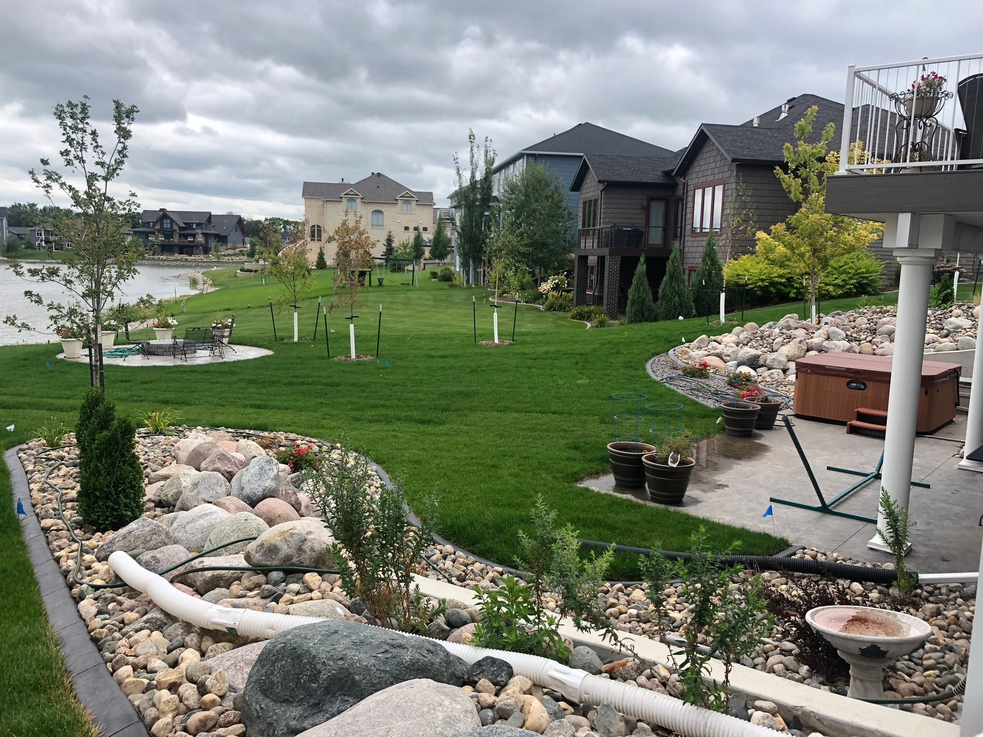A large lawn with a hot tub in the middle of it