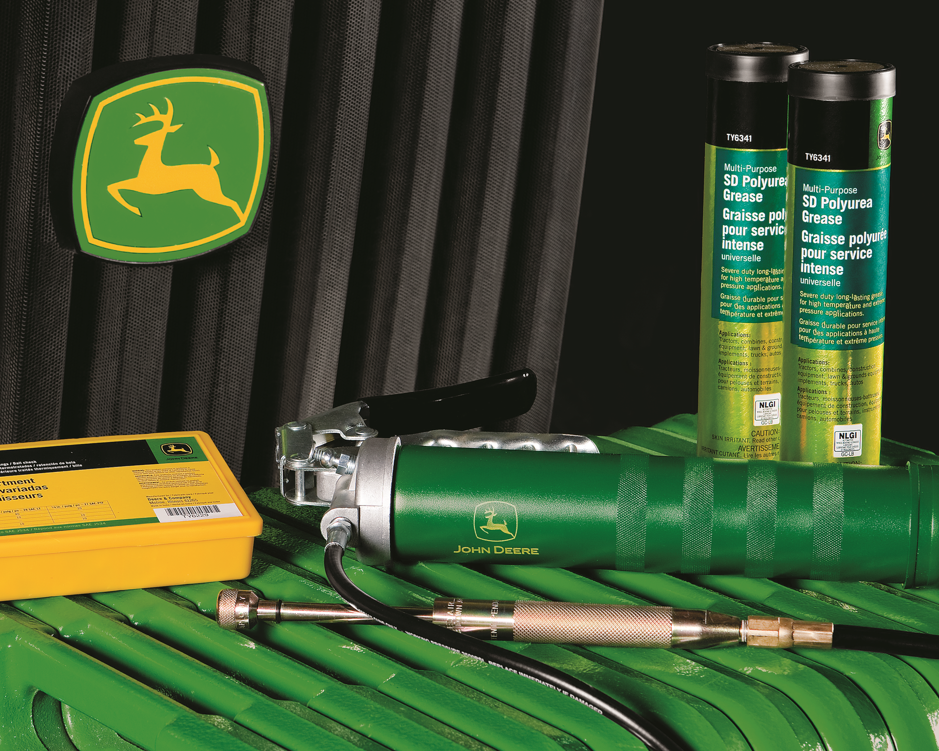 A john deere logo can be seen behind some tools