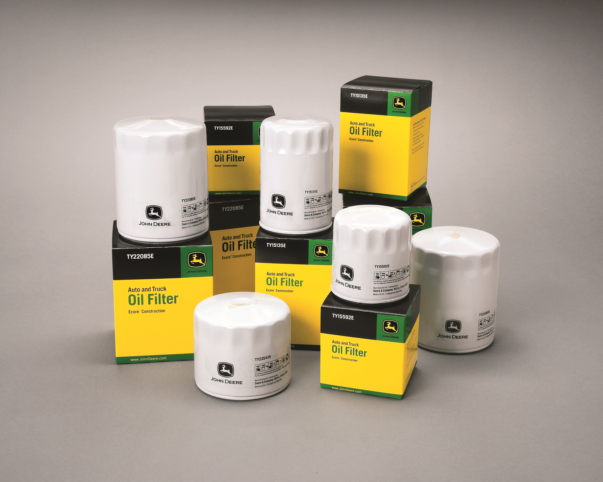 A group of john deere oil filters are stacked on top of each other