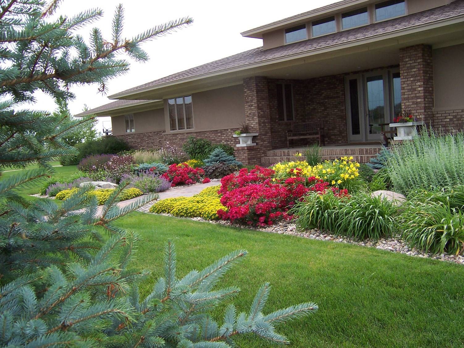 A house with a lot of flowers in front of it
