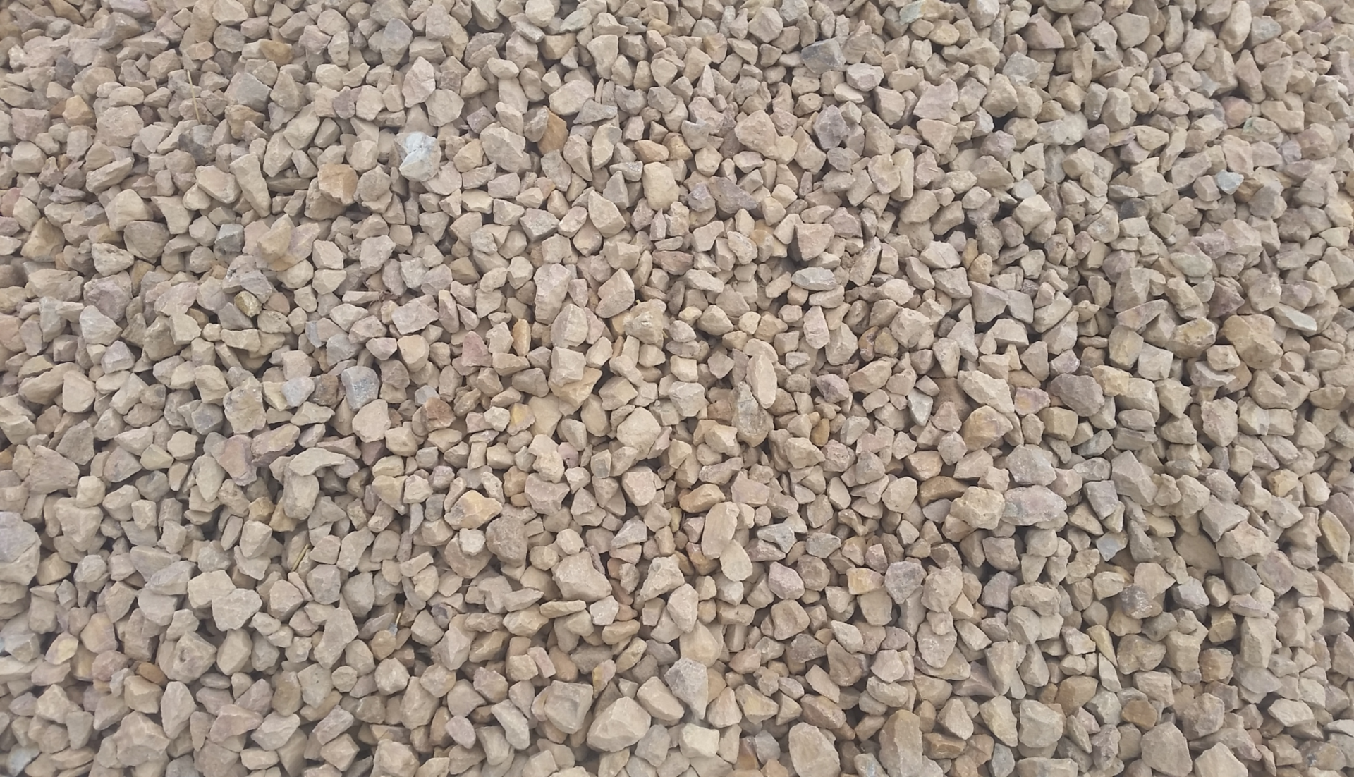 A pile of gravel is sitting on the ground.