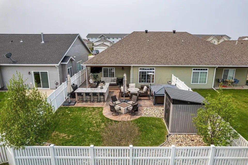An aerial view of a backyard with a fence and a fire pit.