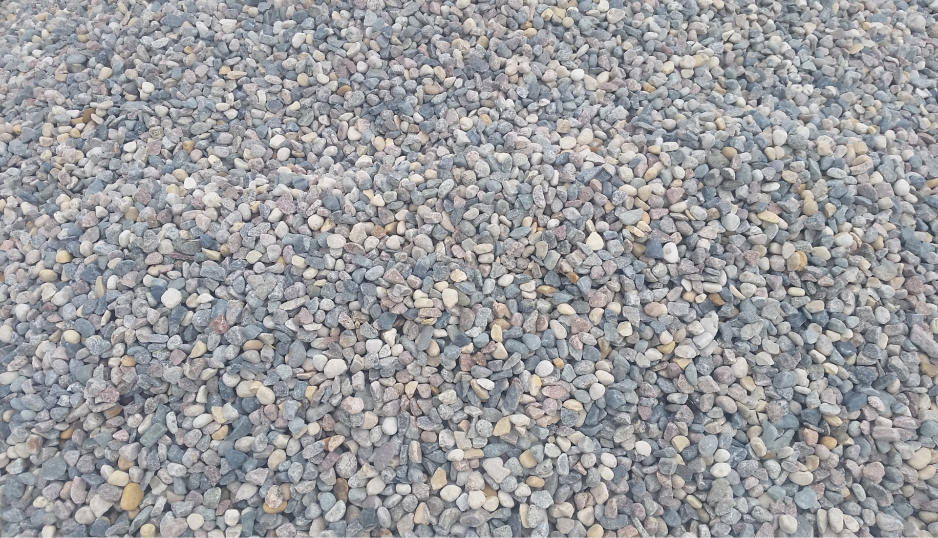 A pile of gravel is sitting on the ground.