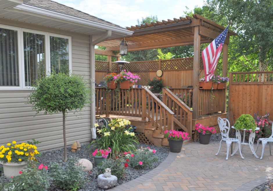 A house with a deck and a pergola with an american flag