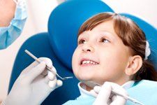 kid smiling while on dental checkup