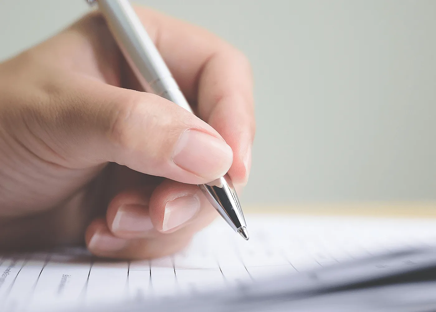 Hand writing with a pen on lined paper