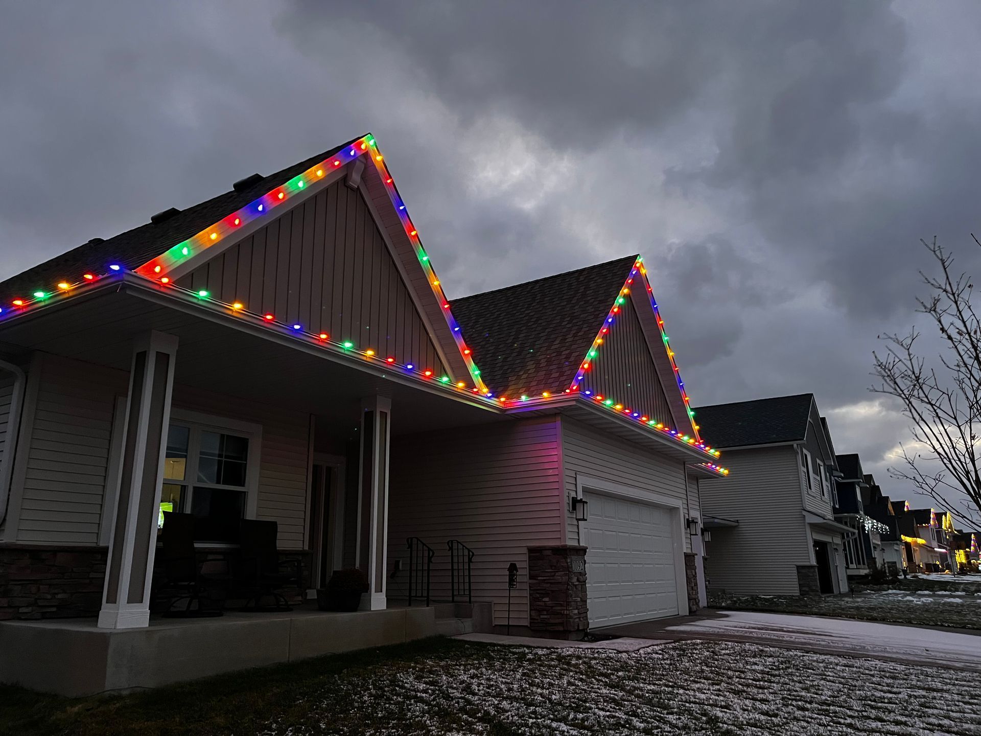 A house with Christmas lights on the roof and porch.