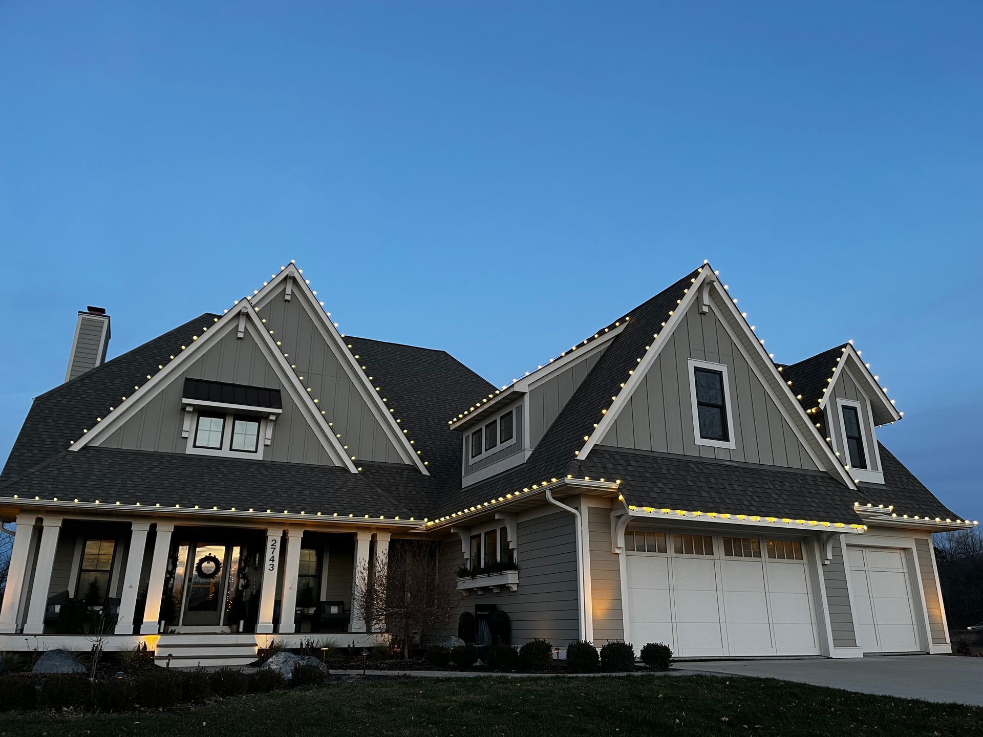 A large house with Christmas lights on the roof.