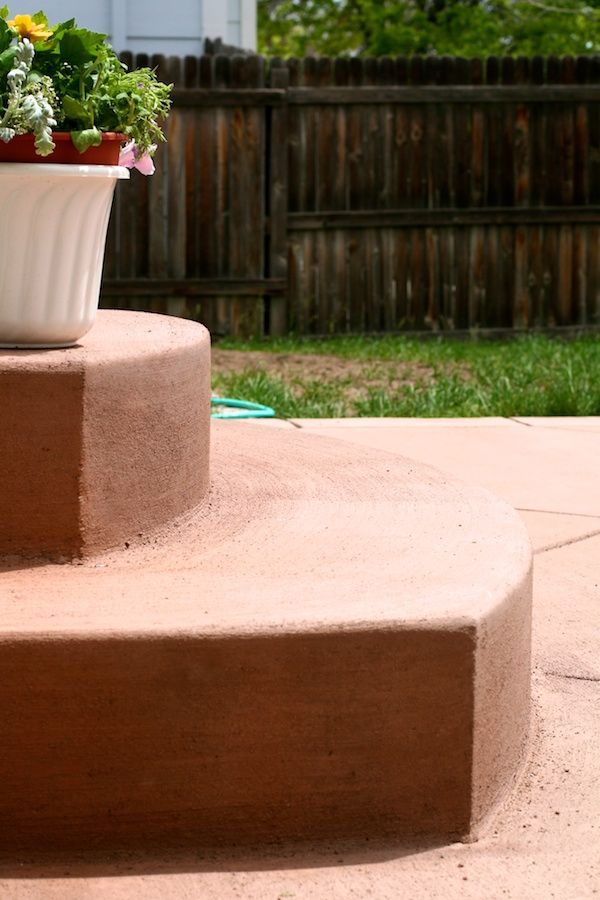 A potted plant sits on top of a set of concrete steps