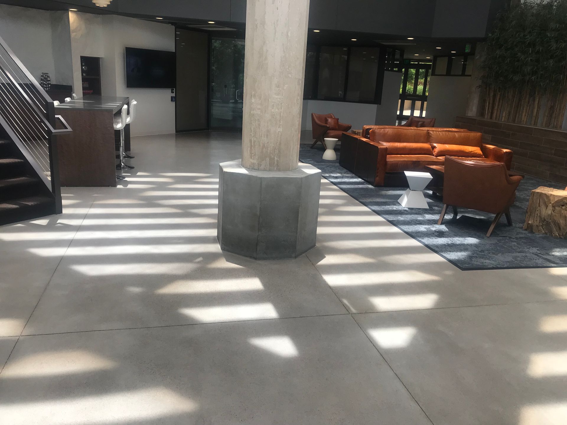 A large room with a lot of furniture and a staircase