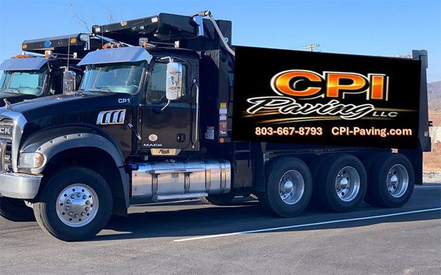 Black Mack dump truck with "CPI Paving LLC" logo on its side.
