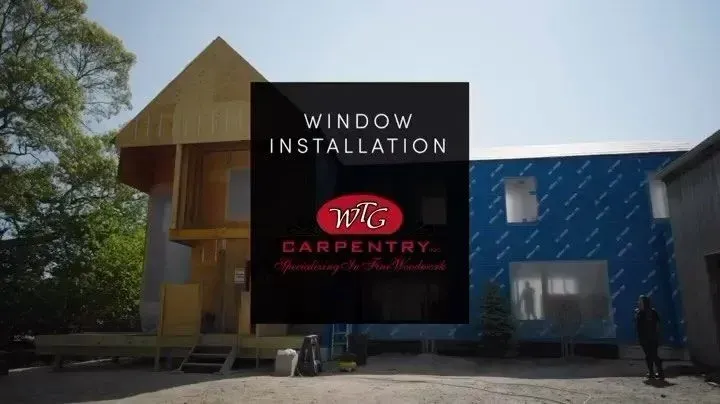 Building under construction, window installation. Company logo overlay with text