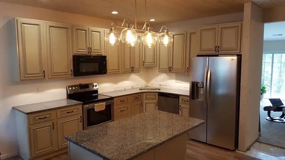 A kitchen with stainless steel appliances and granite counter tops.