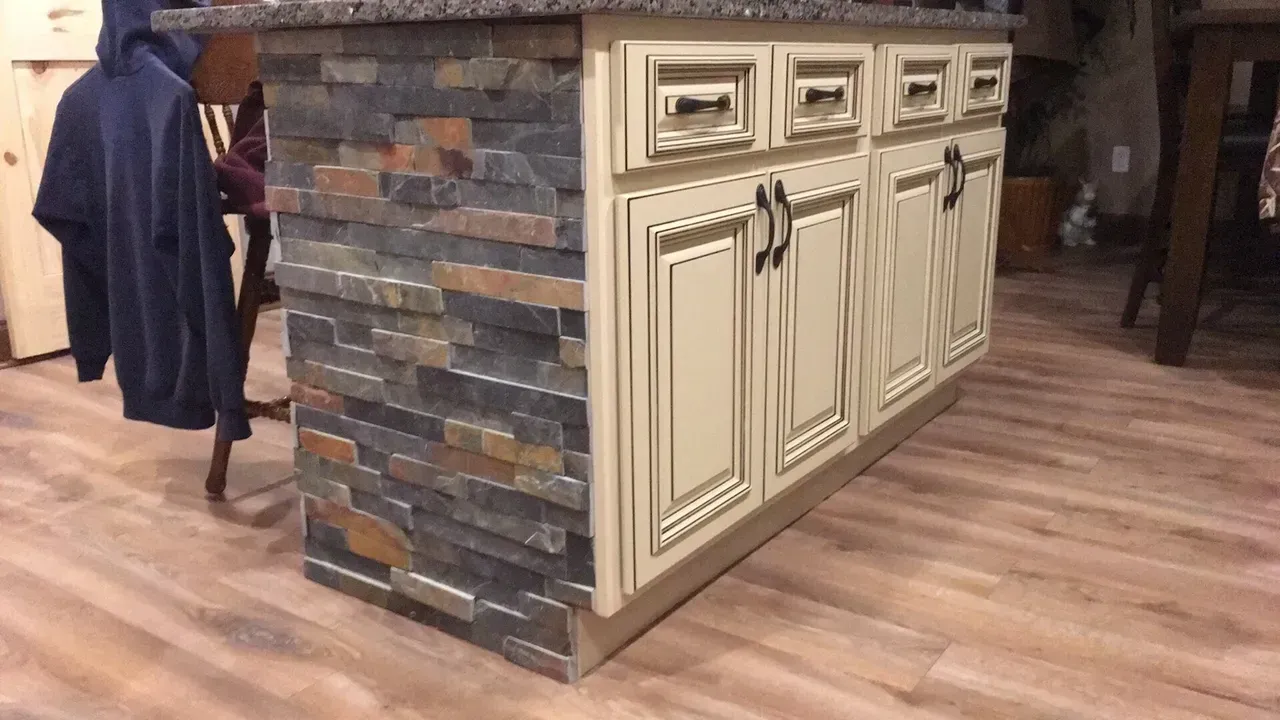 A kitchen under construction with white cabinets and a sink.