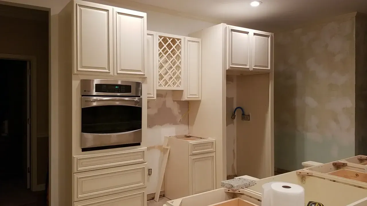 A kitchen with white cabinets and stainless steel appliances.