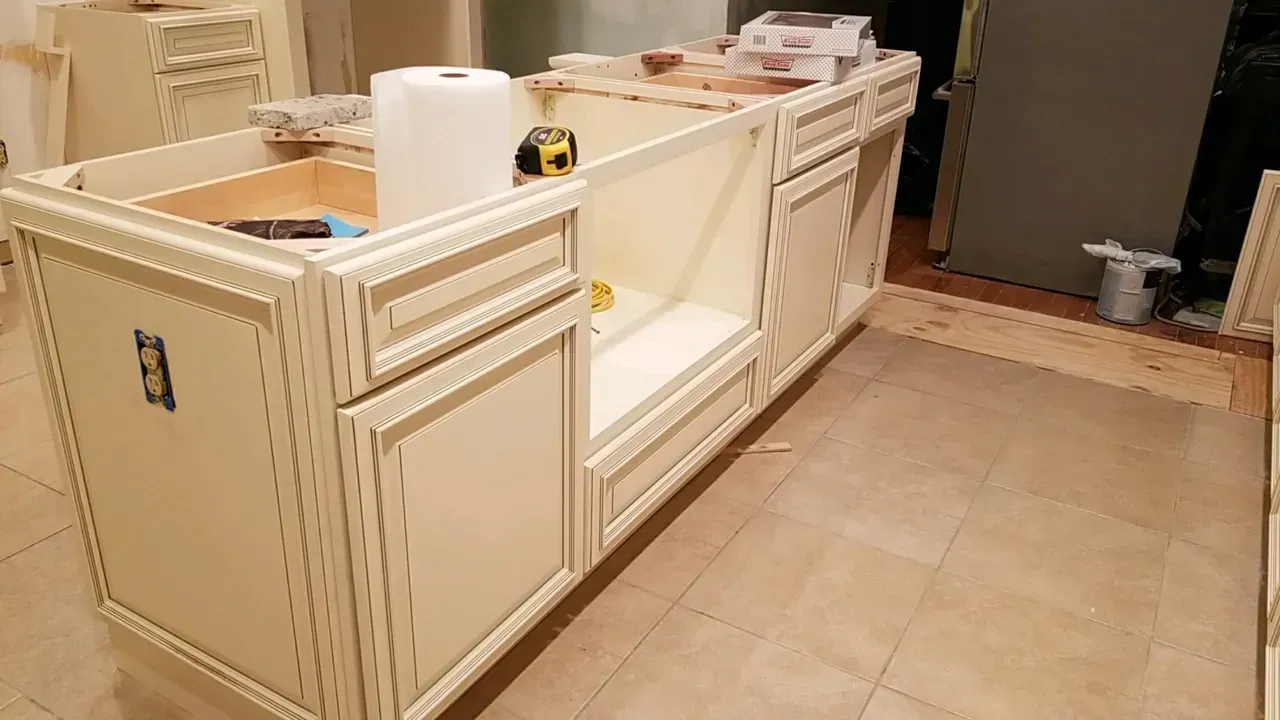 A kitchen cabinet is being built in a room.