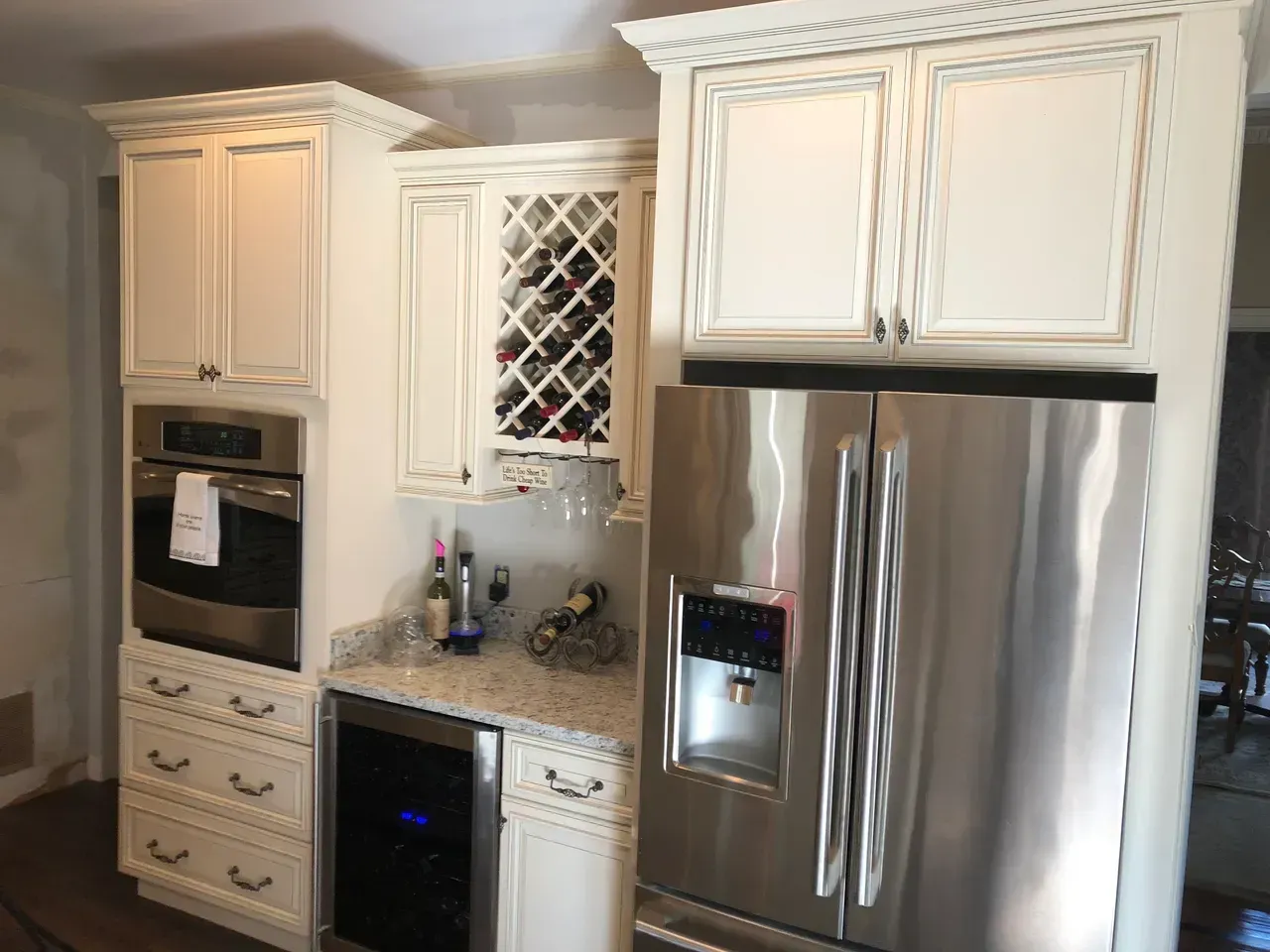 A kitchen with stainless steel appliances and white cabinets.