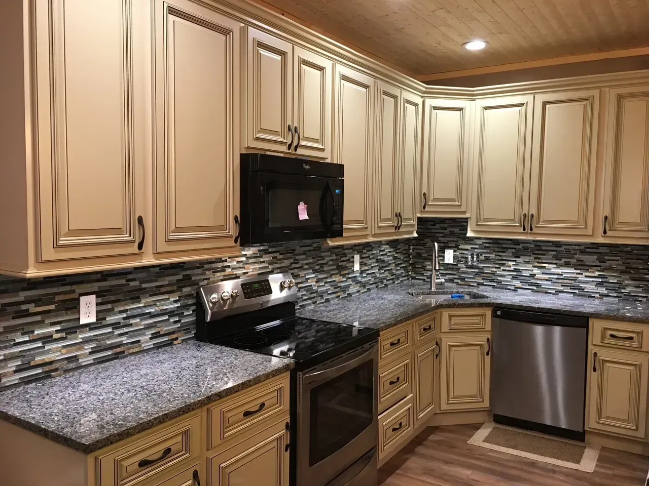 A kitchen with stainless steel appliances and granite counter tops.