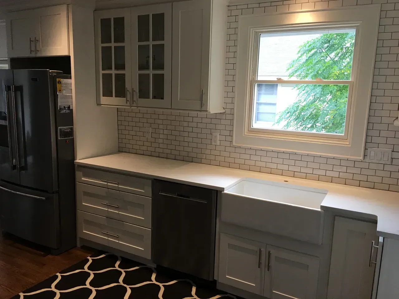 A kitchen with white cabinets and stainless steel appliances