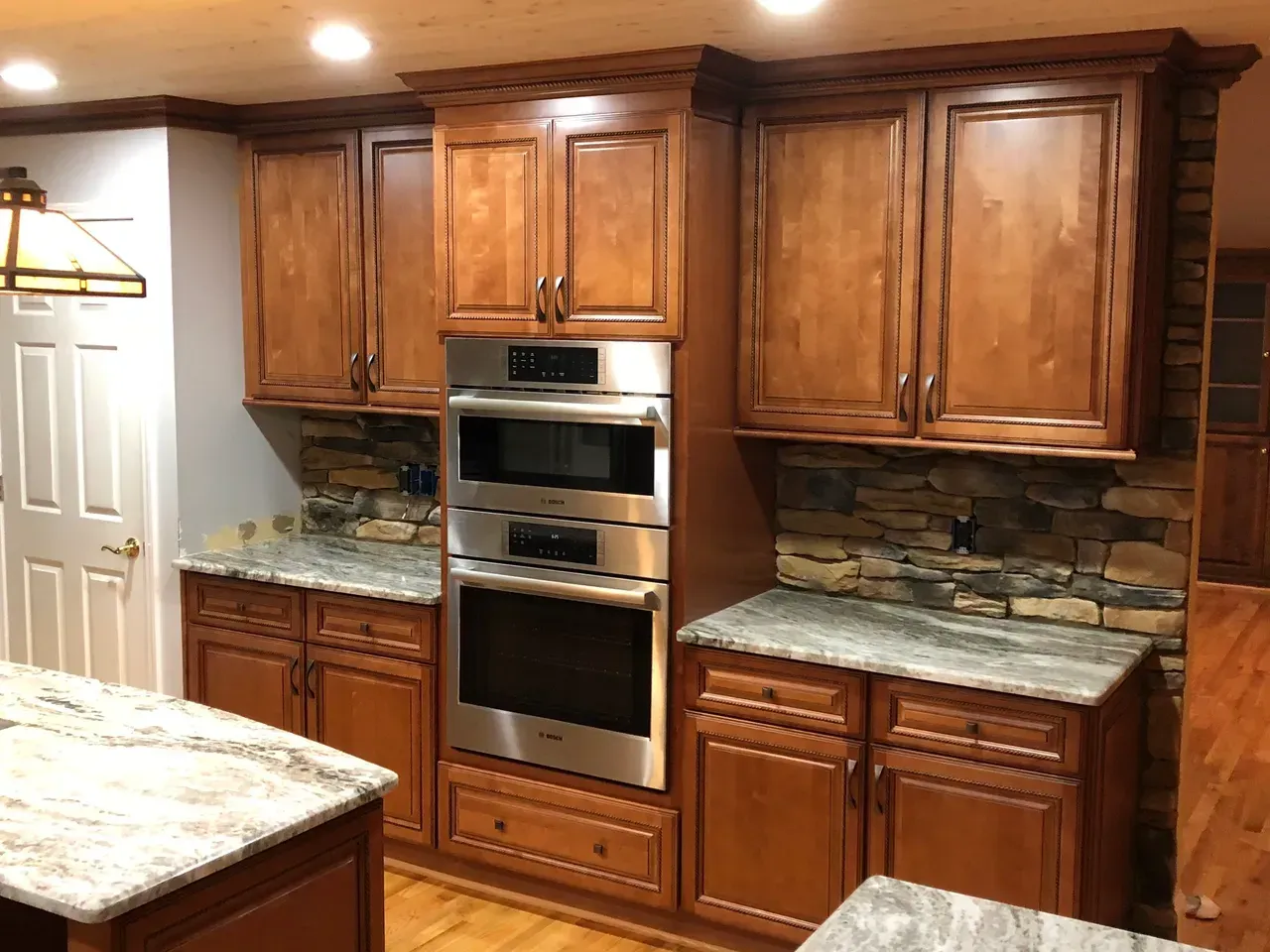 A kitchen with wooden cabinets and stainless steel appliances.