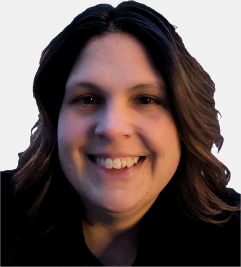 Woman with shoulder-length brown hair smiles at the camera, wearing a black top against a light background.