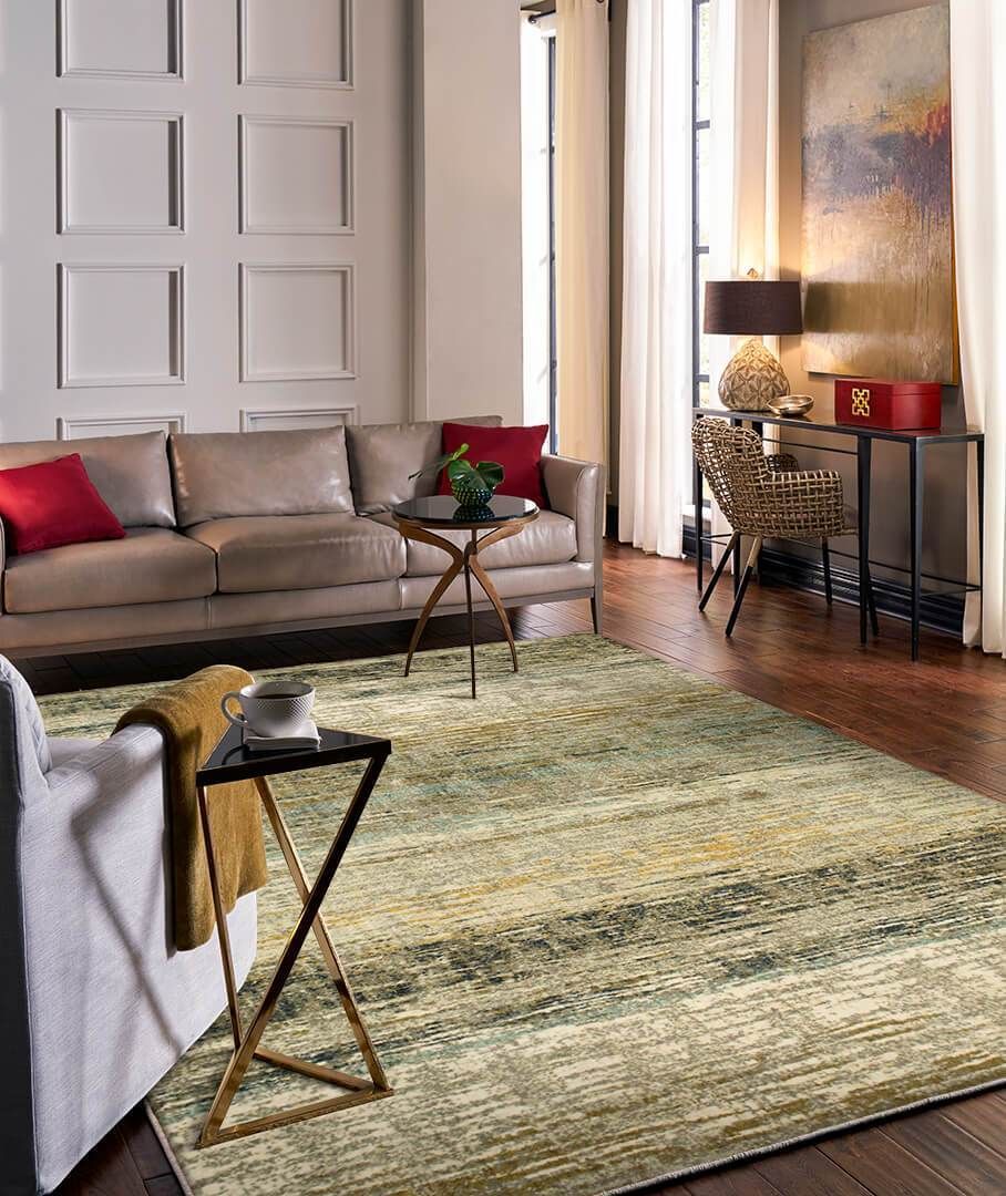 A living room with a couch , chair , table and rug.