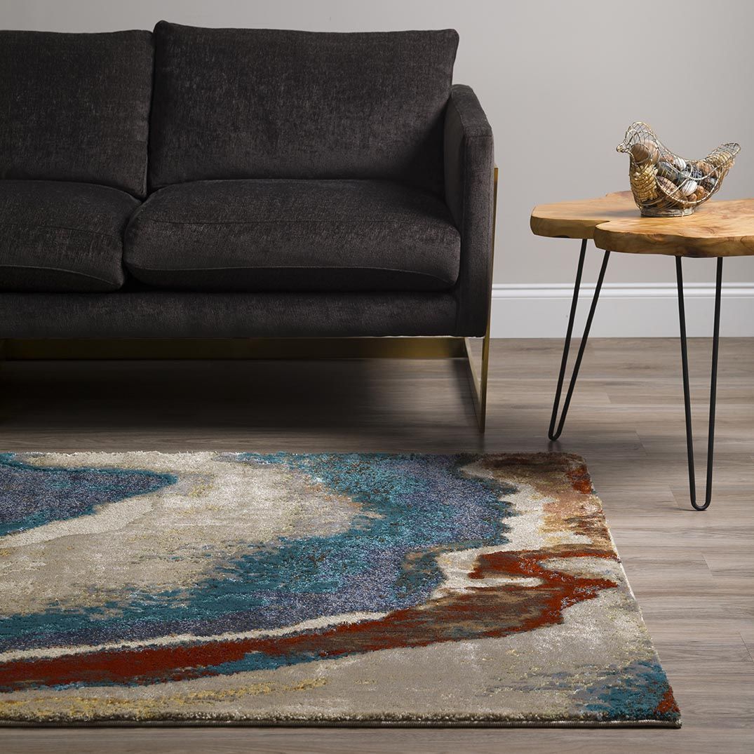 A living room with a couch and a rug on the floor
