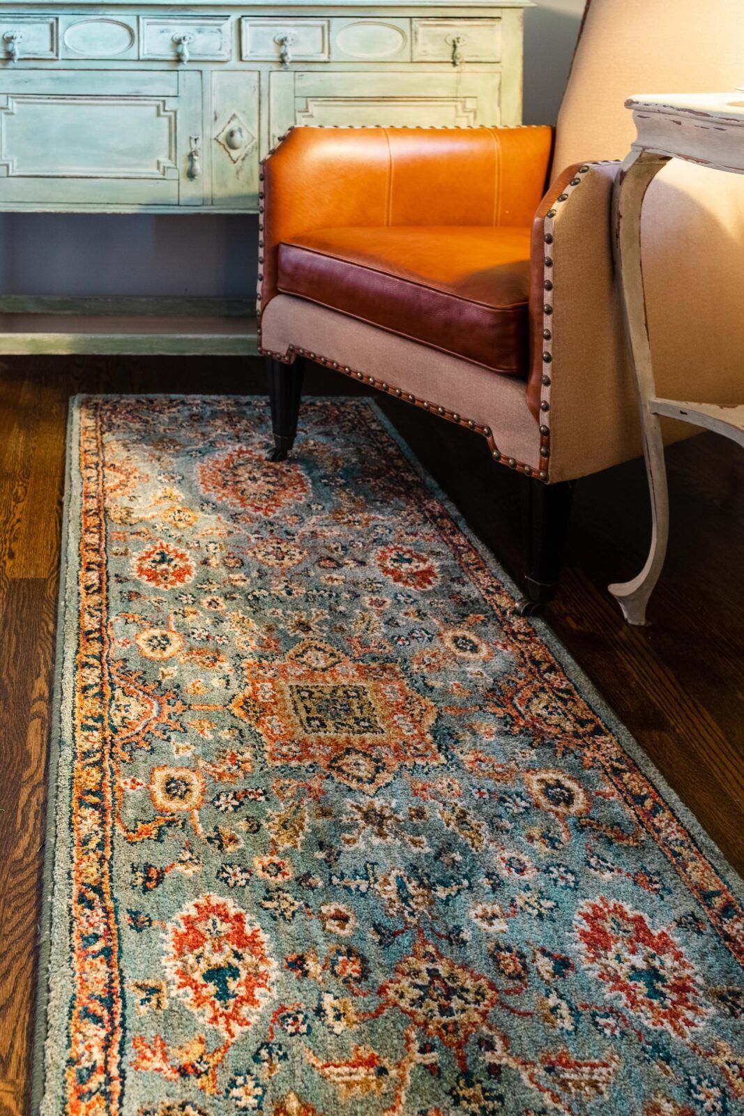 A chair is sitting on a rug next to a table in a room.