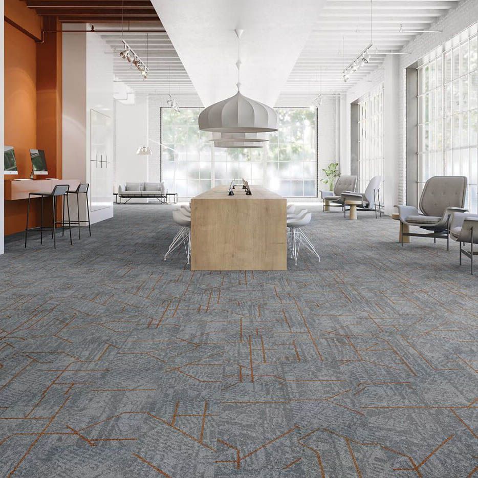 A large room with a lot of furniture and a carpeted floor.
