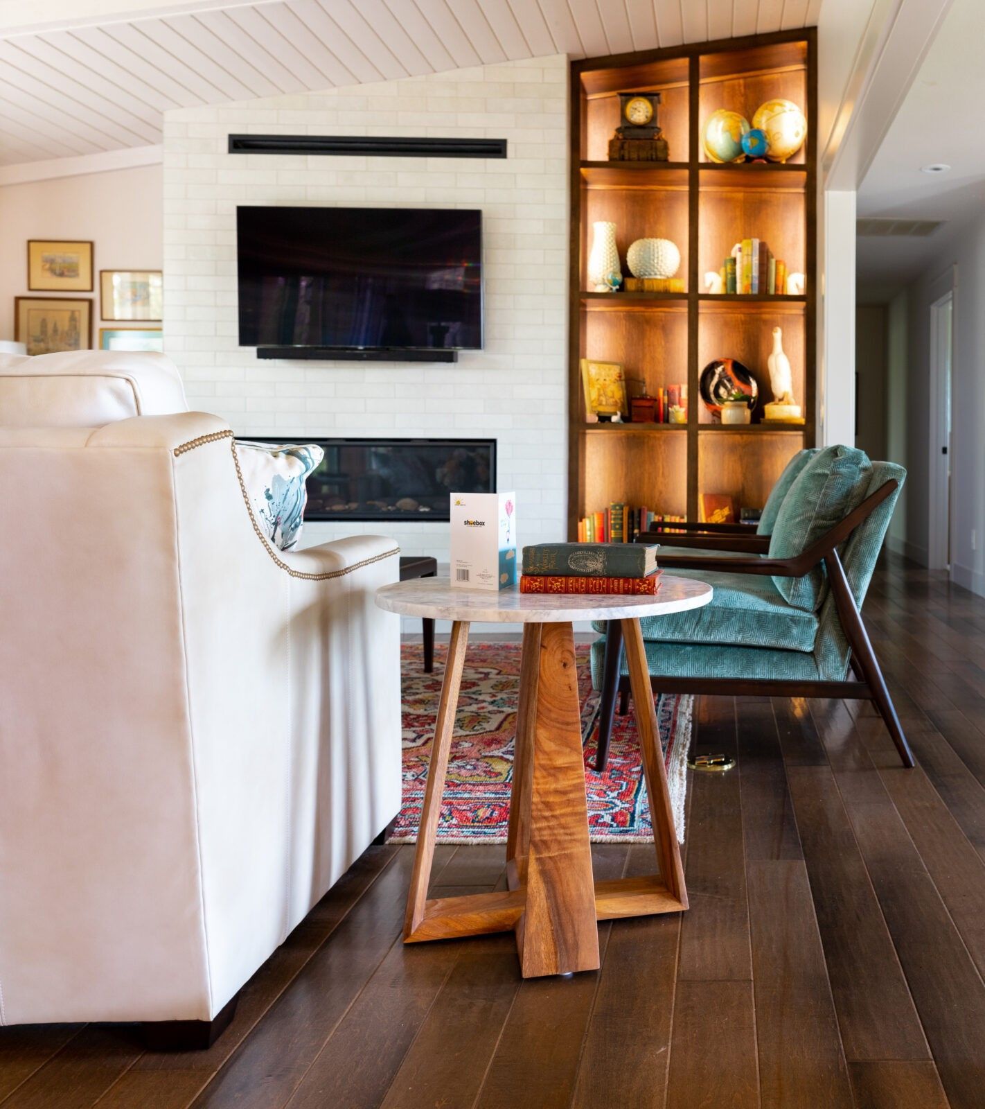 A living room with a fireplace and a flat screen tv