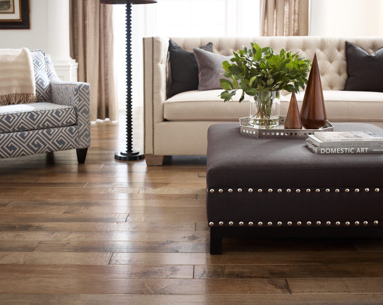 A living room with a couch a chair and an ottoman