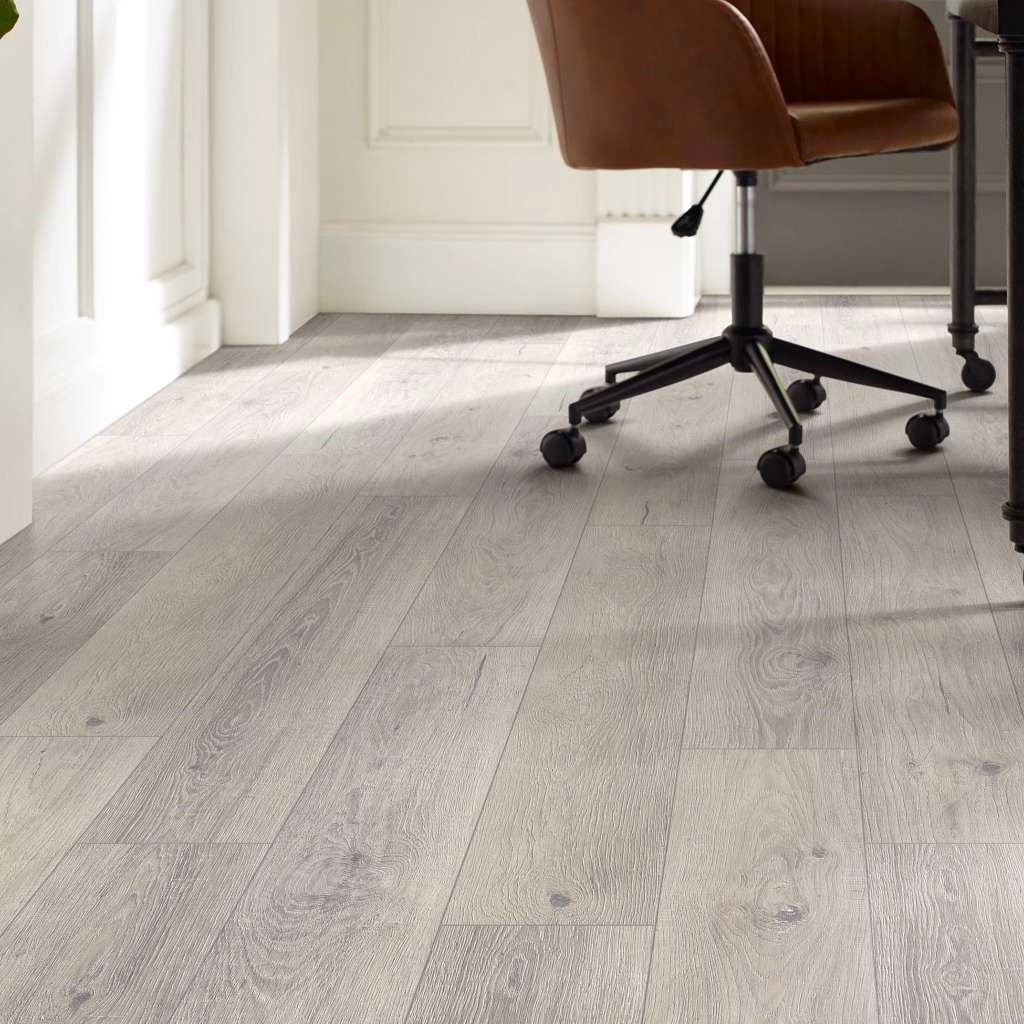 A chair is sitting on a wooden floor next to a desk.